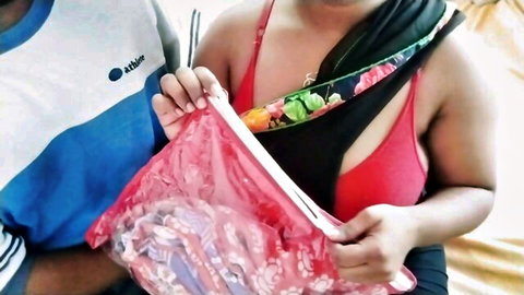 Indian Bhabhi in red bra and floral scarf holds pink bag with uniformed agent