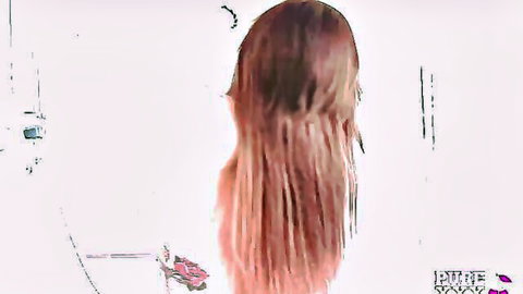 Tattooed babe with long red hair viewed from behind in adult video thumbnail