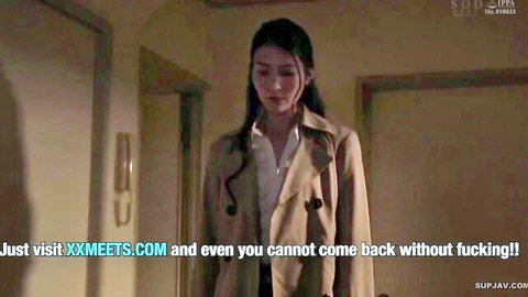 Sad long-haired Japanese Asian woman in open beige trench coat standing in doorway JAV