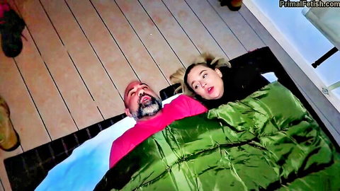 Blake Blossom in sleeping bag with stepdad outdoors camping