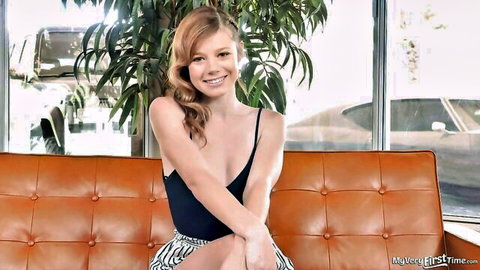 Mia Collins first time on camera, smiling redhead in revealing black top and skirt
