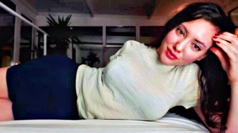 Young Daria lounging seductively in crop top and shorts for JOI tease