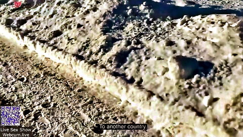 Blurry dirt road landscape with overlaid text 'to another country' no nudity visible