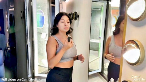 Cami Strella in gray tank top and leggings mirror selfie pose