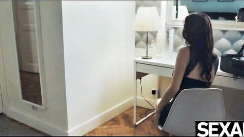 Brunette in sexy black dress sitting at desk, lesbian scissoring preview