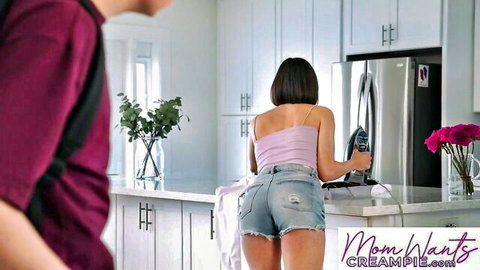 Blaire Johnson in tight denim shorts and tank top ironing, stepson peeking