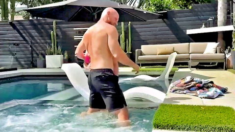 Johnny Sins muscular back in black swim trunks entering pool