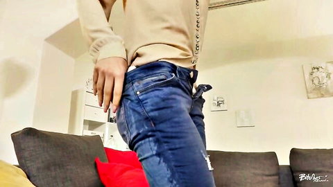 Brunette babe bending over in tight blue jeans teasing her round ass from behind
