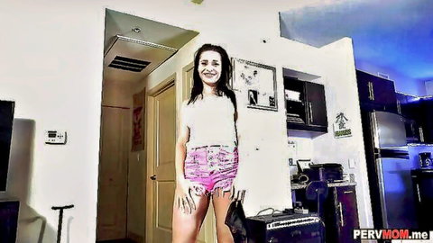 Smiling brunette MILF in white crop top and pink shorts, stepmom tease