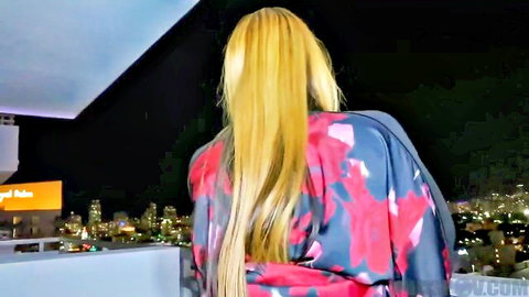 Big booty ebony MILF with long blonde hair in sexy floral dress on balcony
