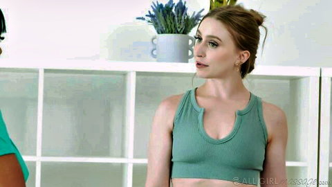 Laney Grey and Ember Snow in tight tank tops, building tension in steamy scene