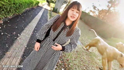 Pretty Asian college girl in checkered dress walking outdoors