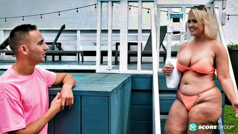 Amber Lace in orange bikini teasing with her curvy MILF ass poolside