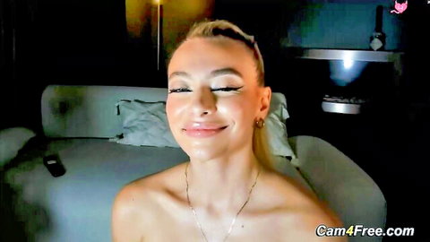 Blonde babe smiling topless in solo cam show