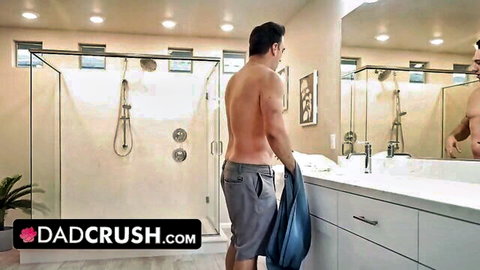 Shirtless muscular stepdad in grey shorts holding towel in bathroom, Dad Crush tease