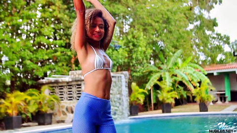 Karo Lander in skimpy white bikini posing seductively by pool