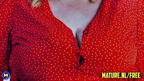 Katie Kay Lane in low-cut red polka-dot dress showing deep cleavage