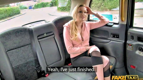 Blonde MILF in pink gym wear relaxes in taxi after workout