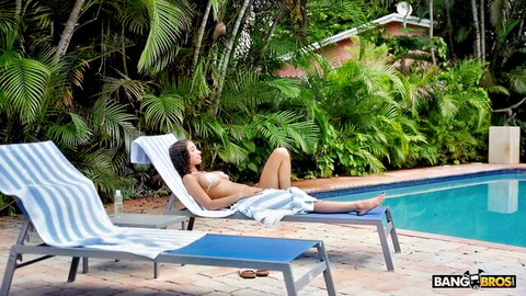 Angelina Love topless ebony beauty relaxing poolside in towel