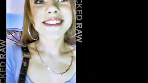 Rose Carter smiling seductively in blue top and hoop earrings
