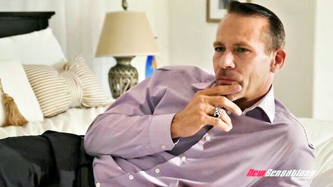 Tommy Pistol in thoughtful pose on bed, Blair Williams group sex scene teaser