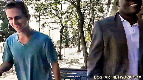 Interracial cuckold thumbnail: Smiling white boy in blue shirt walks with suited black bull outdoors, featuring Cindy Lou
