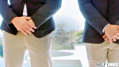 Two suited men standing with hands clasped over crotches outdoors on MILFY.com