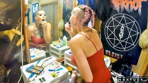 Punk MILF with mohawk applying lipstick in red dress, ready for rough anal creampie