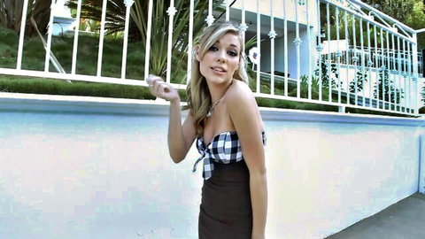 Blonde babe in checkered bikini top teases with deep cleavage in short dress outdoors