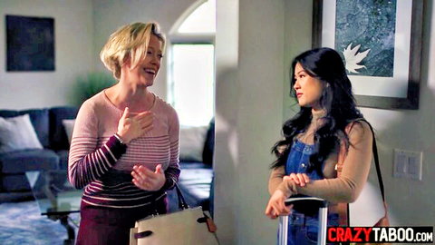 Blonde MILF in striped sweater laughs talking to young Asian in denim overalls