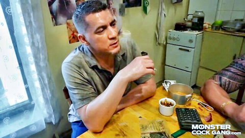 Fit Caucasian man exhaling vape smoke at kitchen table in Monster Cock Gang video
