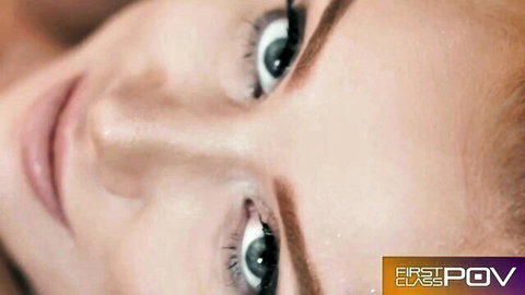 Seductive redhead with green eyes gazes up intensely in first-person POV blowjob tease
