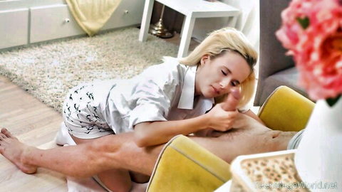 Blonde babe in silver outfit intimately touching man's thigh in teasing foreplay scene