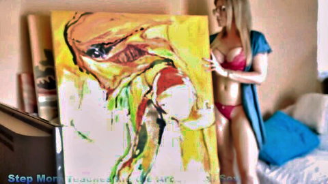 Cory Chase in red lingerie poses seductively with abstract art