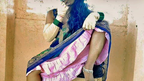 Desisarika in pink sari and blue hair, teasing Indian maid pose