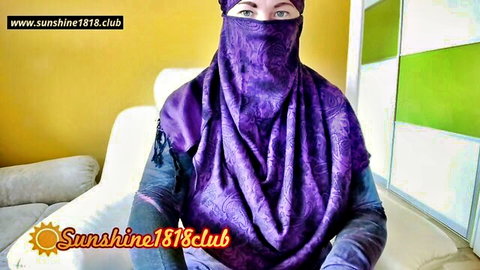 Naughty Arab niqab woman in purple hijab teases with seductive blue eyes on webcam