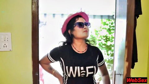 Sexy Indian babe in pink hat and tight WIFI t-shirt posing with arms crossed at doorway