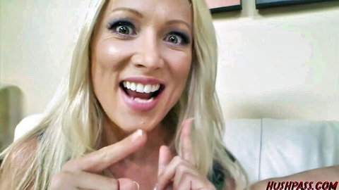 Blonde babe with huge smile flashing peace sign fingers closeup