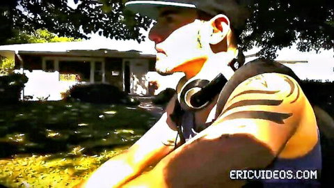 Antonio Biaggi outdoors, muscular Latino with tattoos, backpack and headphones