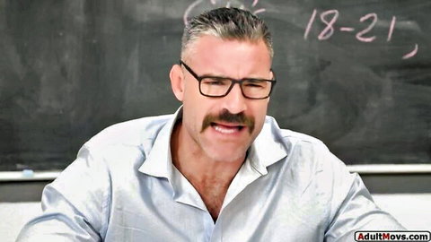 Strict teacher in glasses smirks before spanking petite student