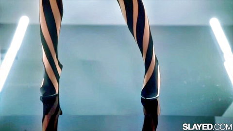 Olivia Jayy in striped stockings teasing legs in sexy pose