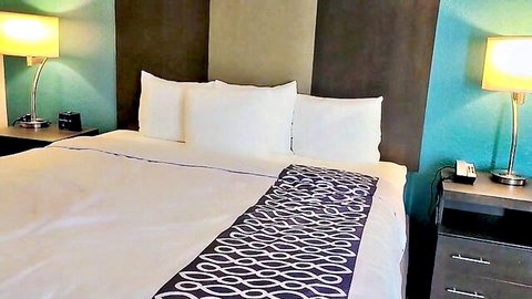 Cozy hotel bedroom setup for steamy lesbian cheating encounter