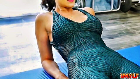 Busty MILF in tight snakeskin bodysuit teases with huge natural tits on yoga mat