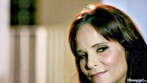 Naughty brunette MILF smiling seductively with full lips and smoky eyes