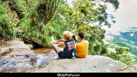 Blond twink and Latino stud chilling by waterfall in outdoor gay scene