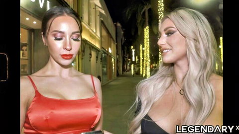 Busty brunette and blonde babes flaunting huge tits in skimpy tops on neon-lit street