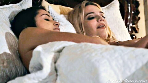 Brunette and blonde babes with small tits lying topless in bed moaning passionately