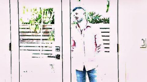 Johnny Hill and Jordan Boss in casual shirts and jeans by window