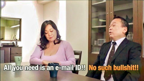 Clothed Southeast Asian cougar in pink sweater and suited man arguing intensely about email ID at office table