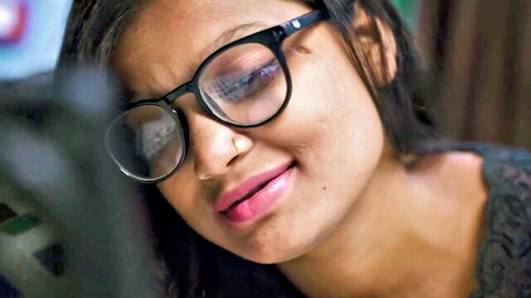 Seductive South Asian girl in glasses with plump glossy lips and teasing gaze